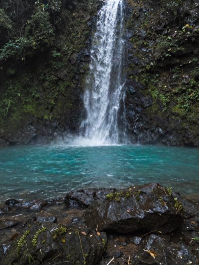 A waterfall in the hills behind the coast